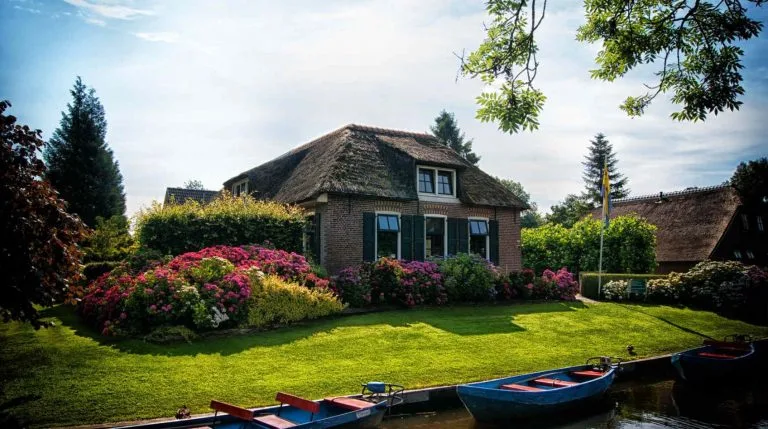 remodeled house green grass beautiful boats quantum vice