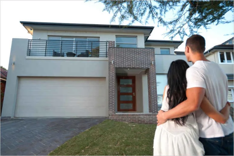 white couple admiring a house new buyers quantum vice